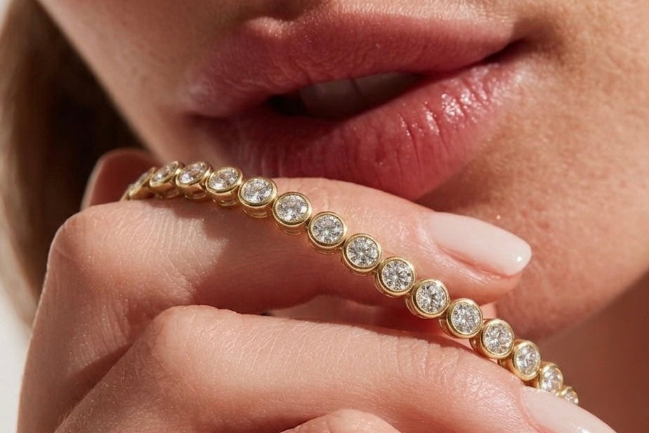 Close-up of a hand wearing a gold bracelet with diamonds