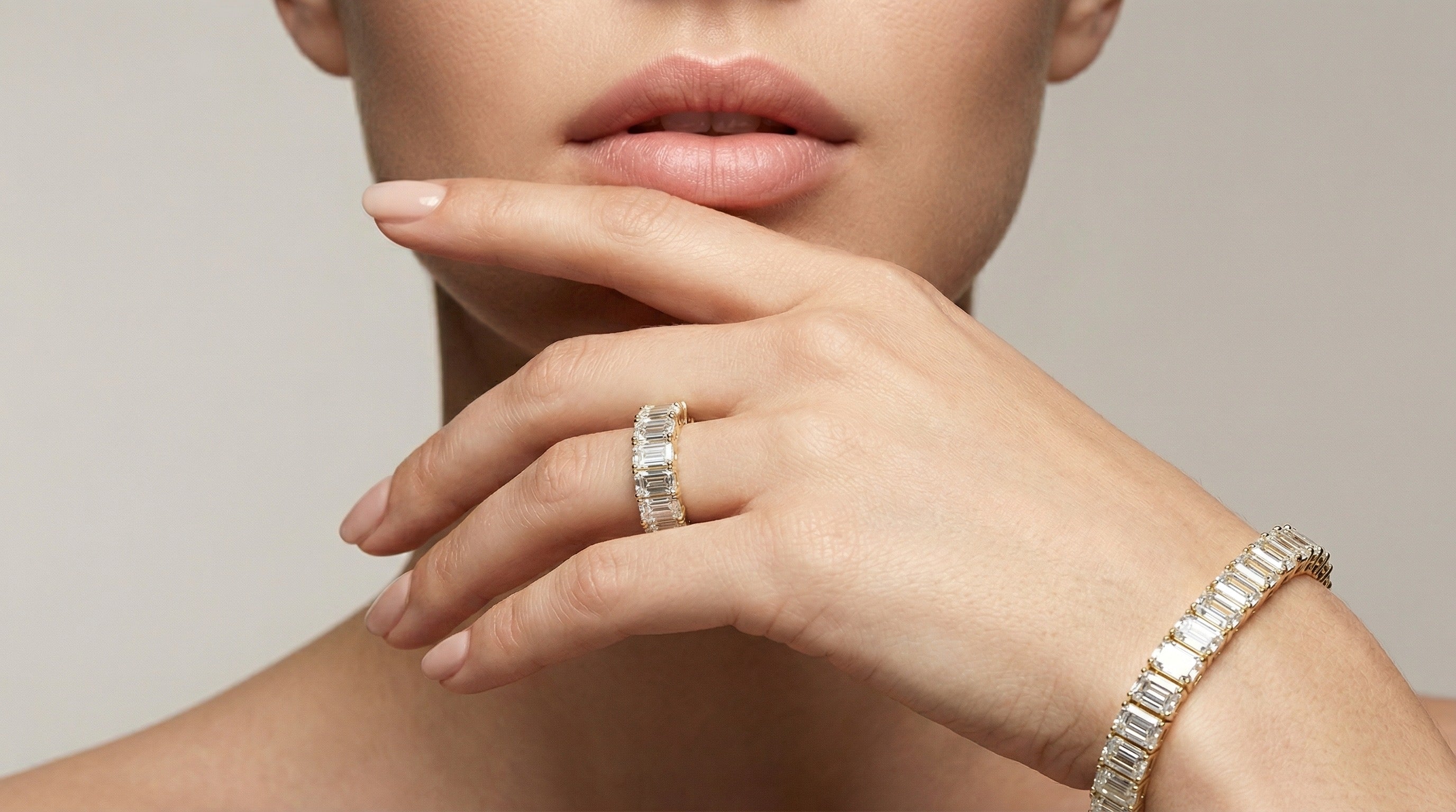 Close-up of a hand wearing a gold ring and bracelet